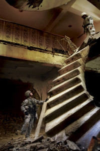 U.S. Army 2nd Lt. Jonathan Hicks attempts to access the upper levels of a building, which was just recaptured from enemy insurgents in Baqubah, Iraq on Jan. 22, 2007. The staircase hangs precariously from the second story after being heavily bombed by American fighter jets during the battle to recover the key location. Hicks’ translator managed to climb the obstacle to be sure the entire building was free of enemy forces.