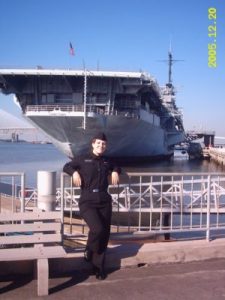 Amanda Lalonde in front of aircraft carrier