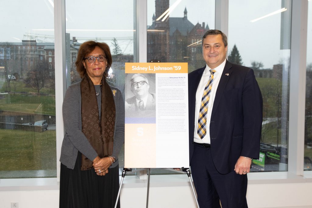 Cydney Johnson (Left), poses with her husband, Jeffry Comanici (right) who was instrumental in advocating for Sidney’s inclusion on the Notable Veteran Alumni list