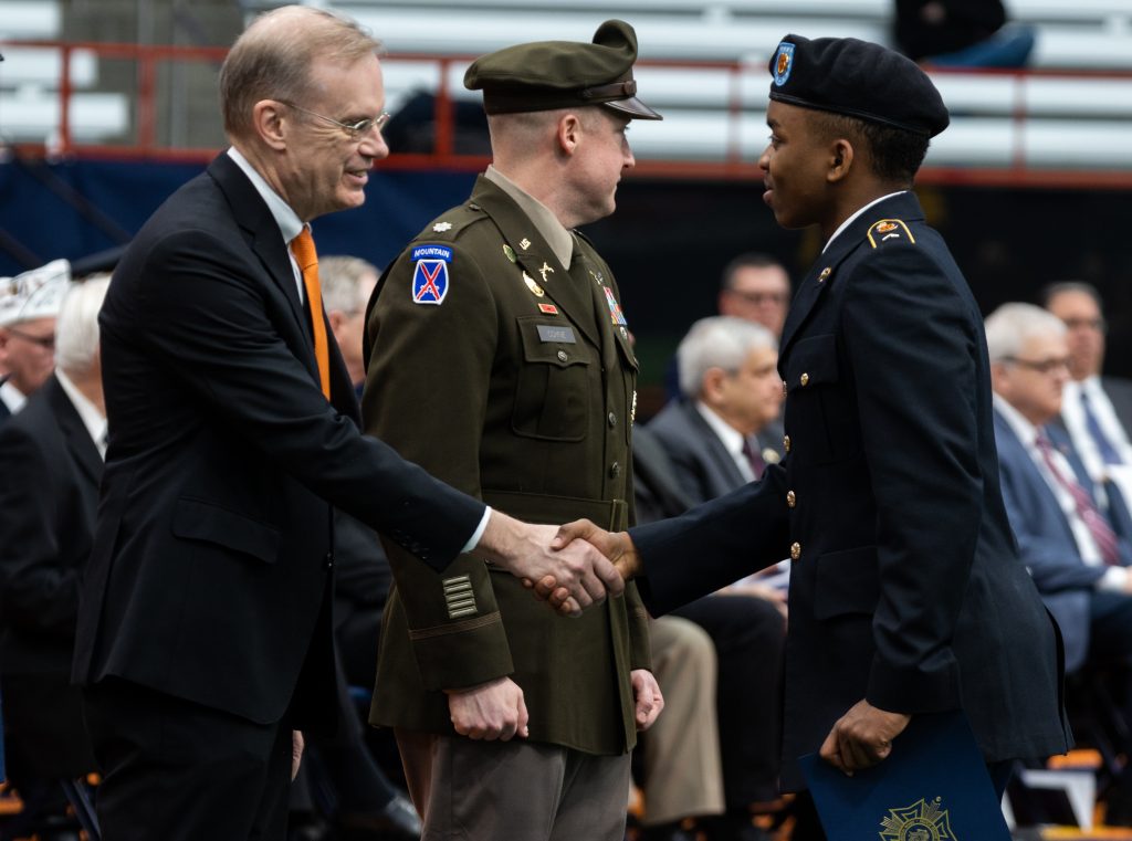 Chancellor Kent Sevyrud shaking hands with ROTC cadet