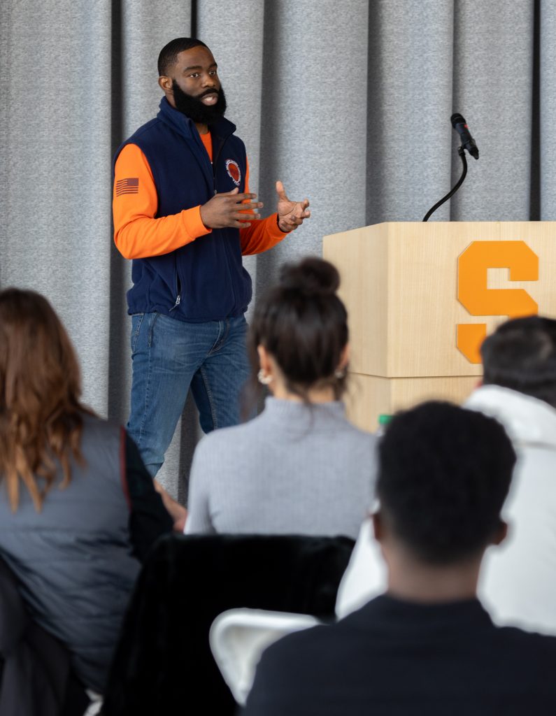 savion pollard speaking at podium.