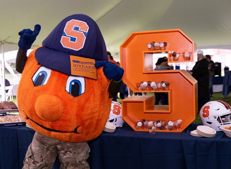 Otto in front of big S at stars and stripes tailgate 2024